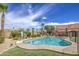 Relaxing backyard featuring a sparkling pool, lush landscaping, and comfortable seating area for outdoor enjoyment at 1217 S Longmore Ct, Chandler, AZ 85286