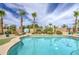 Refreshing pool surrounded by desert landscaping, palm trees, and a basketball hoop at 1217 S Longmore Ct, Chandler, AZ 85286