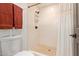 Bright bathroom featuring a tiled shower with pebble floor, toilet, and convenient towel racks at 1235 N Sunnyvale -- # 113, Mesa, AZ 85205