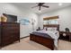 Cozy bedroom featuring natural light, ceiling fan, wood dresser and bedframe, and baseball decor at 1235 N Sunnyvale -- # 113, Mesa, AZ 85205