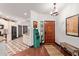 Welcoming foyer with wood flooring, a decorative rug, and a view into the kitchen at 1235 N Sunnyvale -- # 113, Mesa, AZ 85205