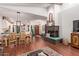 Spacious living room featuring a brick fireplace and open access to the dining area and kitchen at 1235 N Sunnyvale -- # 113, Mesa, AZ 85205