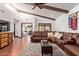 Inviting living room with a comfortable leather sectional, ceiling beams, and natural light at 1235 N Sunnyvale -- # 113, Mesa, AZ 85205