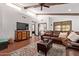 Inviting living room with a comfortable leather sectional, ceiling beams, and natural light at 1235 N Sunnyvale -- # 113, Mesa, AZ 85205
