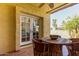 Covered patio with a rustic wooden table and chairs, offering an inviting space for outdoor dining and relaxation at 1235 N Sunnyvale -- # 113, Mesa, AZ 85205