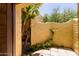 Private outdoor courtyard featuring unique architectural walls, greenery, and tiled patio floor at 1235 N Sunnyvale -- # 113, Mesa, AZ 85205