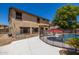 Exterior of home showing a pool with fencing, an outdoor kitchen and mature trees at 14129 W St Moritz Ln, Surprise, AZ 85379