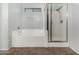 Bathroom with a soaking tub and separate glass enclosed shower area at 14129 W St Moritz Ln, Surprise, AZ 85379