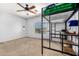 Minimalist bedroom with a loft bed, desk, and carpeted floors at 14129 W St Moritz Ln, Surprise, AZ 85379