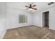Bright bedroom with plush carpeting and a ceiling fan for added comfort at 14129 W St Moritz Ln, Surprise, AZ 85379