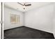 Unfurnished bedroom with a ceiling fan and dark carpet at 14129 W St Moritz Ln, Surprise, AZ 85379