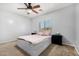 Comfortable bedroom with a ceiling fan and a window providing natural light at 14129 W St Moritz Ln, Surprise, AZ 85379