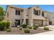 Charming two-story home with a well-manicured front yard and an attached two-car garage at 14129 W St Moritz Ln, Surprise, AZ 85379