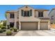 Attractive home showcasing its stucco exterior, tiled roof, and a spacious driveway leading to a two-car garage at 14129 W St Moritz Ln, Surprise, AZ 85379