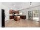 Eat-in kitchen with island, granite countertops, tiled flooring, and stainless steel appliances at 14129 W St Moritz Ln, Surprise, AZ 85379