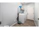 Functional laundry room with a washer, dryer, and storage shelving at 14129 W St Moritz Ln, Surprise, AZ 85379