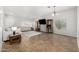 Open living room with neutral walls, tile flooring, two sofas, and windows for natural light at 14129 W St Moritz Ln, Surprise, AZ 85379