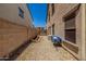 Narrow side yard area with gravel landscaping and block wall at 14129 W St Moritz Ln, Surprise, AZ 85379