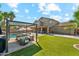Sprawling backyard with covered patio, outdoor seating, artificial grass, and a sparkling pool; great for entertaining at 14364 W Cameron Dr, Surprise, AZ 85379