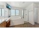 Bright bathroom featuring soaking tub, separate glass-enclosed shower, and modern fixtures at 14364 W Cameron Dr, Surprise, AZ 85379