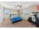 Inviting bedroom with two large windows and modern ceiling fan; ideal for comfortable living at 14364 W Cameron Dr, Surprise, AZ 85379