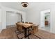 Dining room features a modern table, decorative light fixture and adjacent doorway to another room at 14364 W Cameron Dr, Surprise, AZ 85379