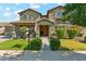 Charming two-story home with a landscaped front yard, inviting porch, and American flag at 14364 W Cameron Dr, Surprise, AZ 85379