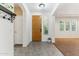 Bright foyer with tiled floor, coat closet, and view into the adjacent living area at 14364 W Cameron Dr, Surprise, AZ 85379