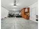 Spacious garage featuring a variety of vehicles and abundant cabinet storage, plus an overhead door at 14364 W Cameron Dr, Surprise, AZ 85379