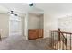 Upstairs landing area with built-in cabinetry, ceiling fans, and decorative staircase at 14364 W Cameron Dr, Surprise, AZ 85379