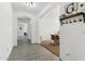 Hallway with tiled floor leads to dining area and other rooms, coat rack on wall at 14364 W Cameron Dr, Surprise, AZ 85379