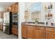 Modern kitchen boasts stainless steel appliances and granite countertops and stylish cabinets at 14364 W Cameron Dr, Surprise, AZ 85379