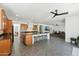 Spacious kitchen boasts a large island with seating, granite counters, and seamless open floor plan at 14364 W Cameron Dr, Surprise, AZ 85379