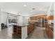 Open kitchen with granite countertops, stainless appliances, large island with seating, and backyard patio access at 14364 W Cameron Dr, Surprise, AZ 85379