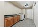 Functional laundry room with ample counter space, cabinetry, and modern washer/dryer units at 14364 W Cameron Dr, Surprise, AZ 85379