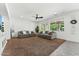 Spacious living room with plush carpeting, ceiling fan, and ample natural light at 14364 W Cameron Dr, Surprise, AZ 85379