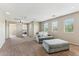 Spacious living room featuring plush carpet, natural light, and comfortable seating area at 14364 W Cameron Dr, Surprise, AZ 85379