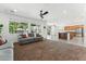 Spacious living room features plush carpeting, large windows, ceiling fan and adjacent open concept kitchen at 14364 W Cameron Dr, Surprise, AZ 85379