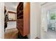 Walk-in closet with custom shelves and drawers leading into an attached full bathroom at 14364 W Cameron Dr, Surprise, AZ 85379
