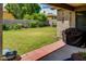 Covered patio overlooking a well-maintained backyard with a lush lawn and privacy wall at 17765 W Ventura St, Surprise, AZ 85388
