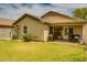 Backyard of home with healthy lawn, stucco walls and covered patio at 17765 W Ventura St, Surprise, AZ 85388
