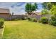 Spacious backyard featuring a lush lawn and mature landscaping at 17765 W Ventura St, Surprise, AZ 85388