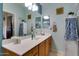 Bright bathroom with a double vanity, large mirror, and custom cabinetry for storage at 17765 W Ventura St, Surprise, AZ 85388