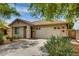 Exterior view of a single Gathering home with well-manicured landscaping and a two-car garage at 17765 W Ventura St, Surprise, AZ 85388
