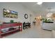 Open living area with tile flooring, modern decor, and an adjacent dining area and kitchen at 17765 W Ventura St, Surprise, AZ 85388