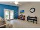 Living room showcasing French doors, a television, and views of the backyard at 17765 W Ventura St, Surprise, AZ 85388