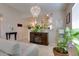 Elegant living room with a modern chandelier, an electric fireplace, and view into the kitchen at 17765 W Ventura St, Surprise, AZ 85388