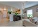Open-concept living room featuring a stylish chandelier and seamless flow into the kitchen at 17765 W Ventura St, Surprise, AZ 85388