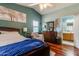 A cozy main bedroom with hardwood floors, vaulted ceiling, and an ensuite bathroom at 17765 W Ventura St, Surprise, AZ 85388