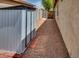 Side yard of home featuring gravel, a storage shed, and access gate at 17765 W Ventura St, Surprise, AZ 85388